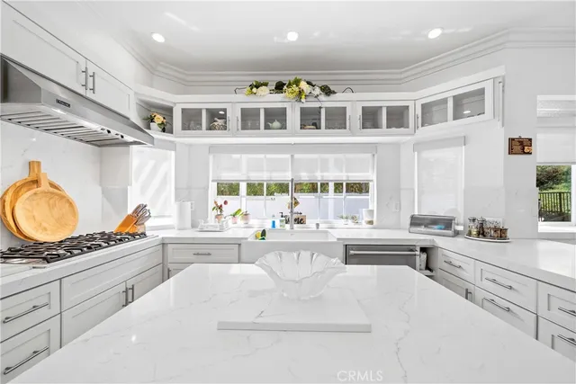 a kitchen with stainless steel appliances kitchen island granite countertop a sink and cabinets