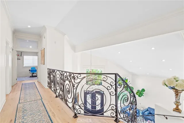 a large bedroom with a bed and a large mirror