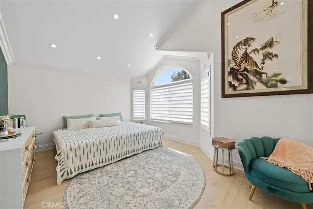 a bedroom with a large bed and a window