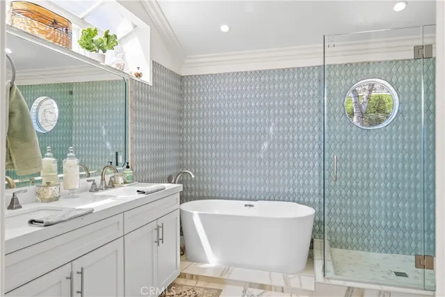 a bathroom with a sink a toilet a glass door shower and mirror