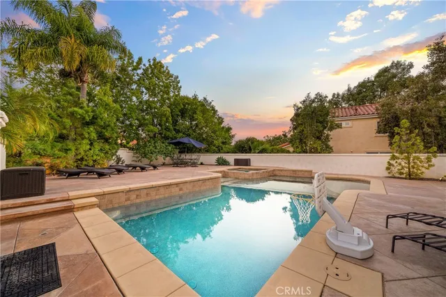 a small pool with some trees in the background