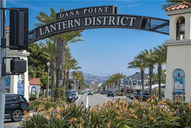 a view of a swimming pool with a bench and trees in the background