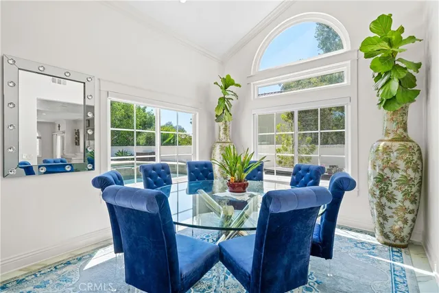 a dining room with furniture potted plants and a potted plant
