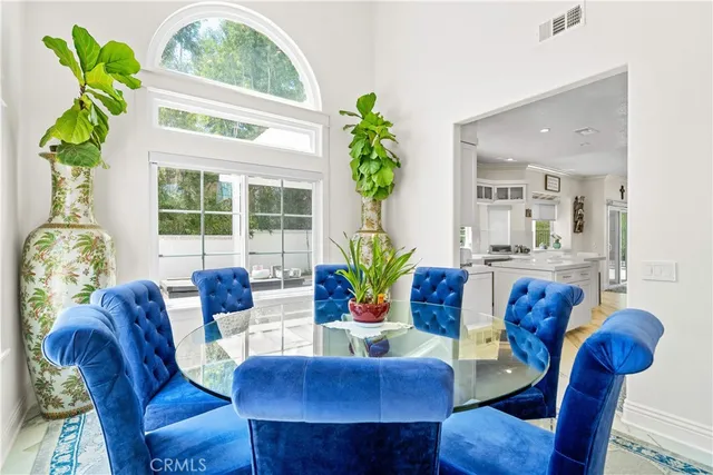 a living room with furniture potted plant and a large window