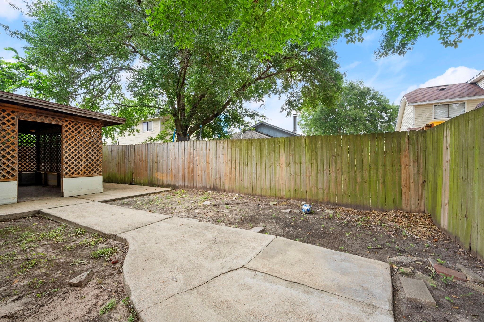 11718 Ridge Run Drive Houston, TX 77064 - Photo 7 of 17 a view of a backyard with a barbeque and wooden fence