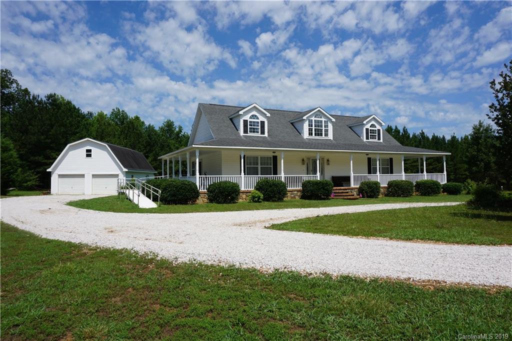 a front view of a house with a yard and pathway