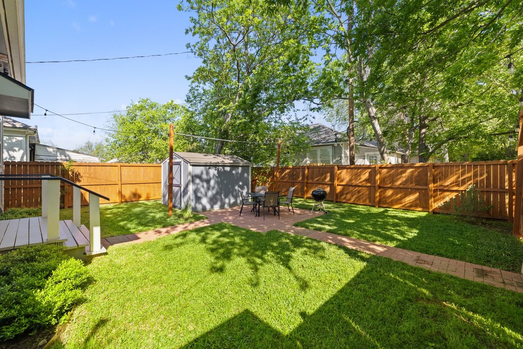 314 West 3rd Street Taylor, TX 76574 - Photo 23 of 27 Beautifully manicured yard with storage shed for lawn equipment