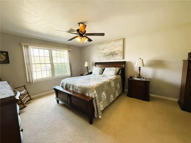 a bedroom with a bed dresser and a window