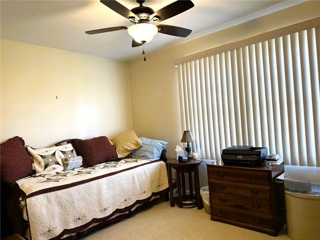 a bathroom with a granite countertop toilet sink and mirror