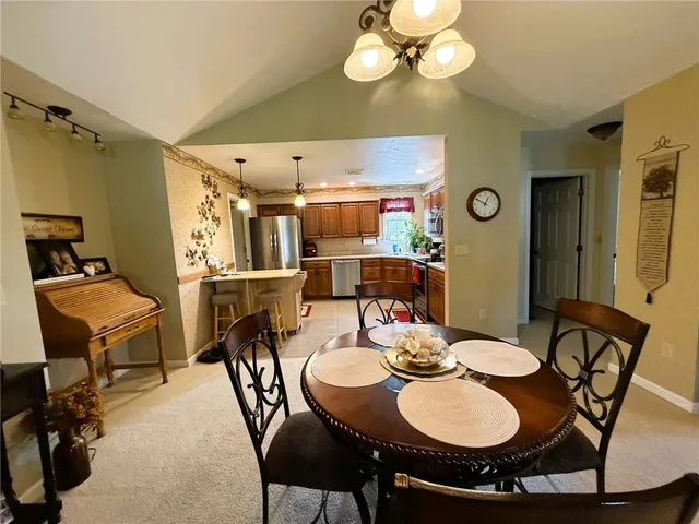 a view of a dining room with furniture and chandelier