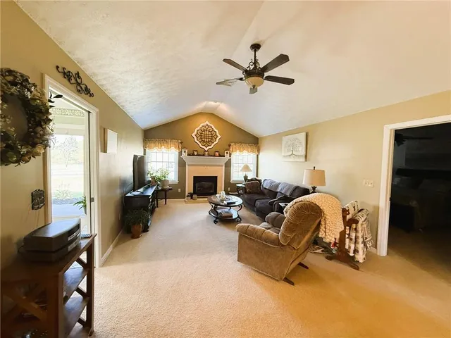 a living room with fireplace furniture and a window