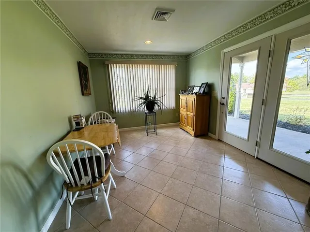 a view of a hallway with furniture and a floor to ceiling window