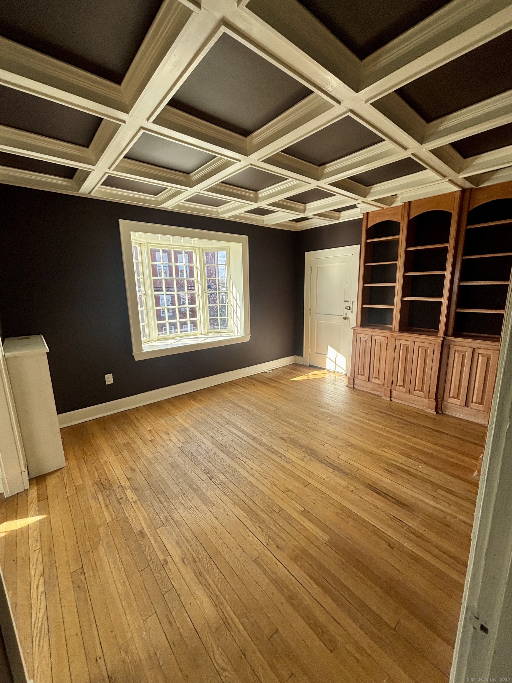 554 Brewster Street, Unit 4 Bridgeport, CT 06605 - Photo 1 of 24 a view of an empty room with wooden floor and a window