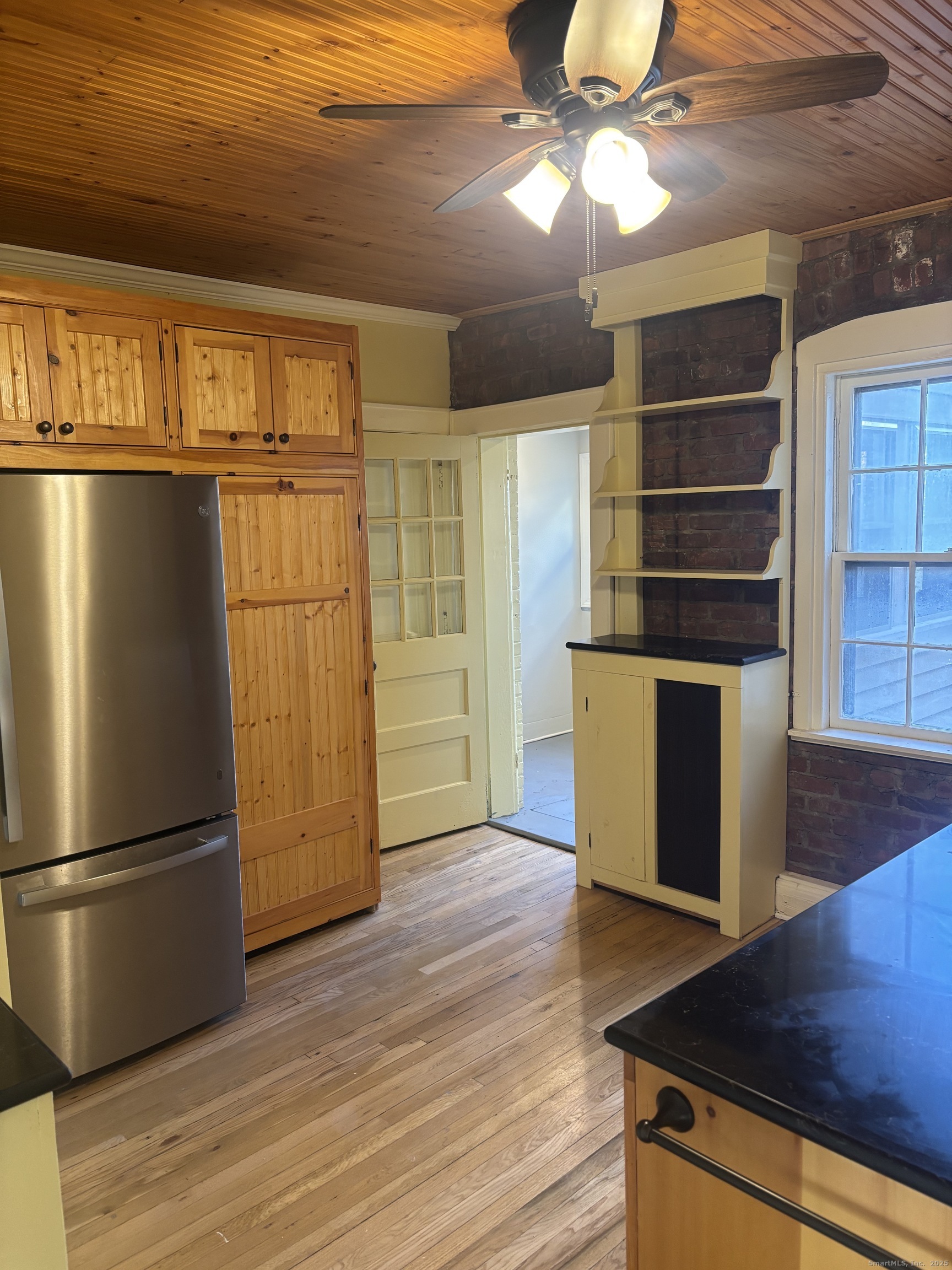 554 Brewster Street, Unit 4 Bridgeport, CT 06605 - Photo 15 of 24 a view of a kitchen with wooden floor and refrigerator