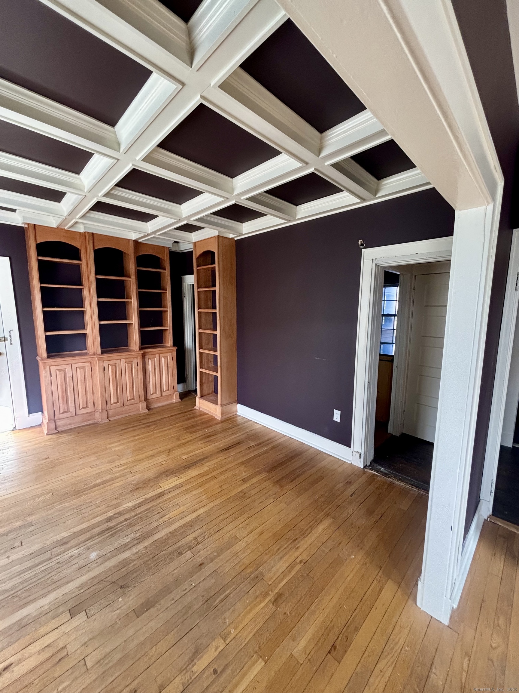 554 Brewster Street, Unit 4 Bridgeport, CT 06605 - Photo 4 of 24 a view of an empty room with wooden floor and a ceiling fan