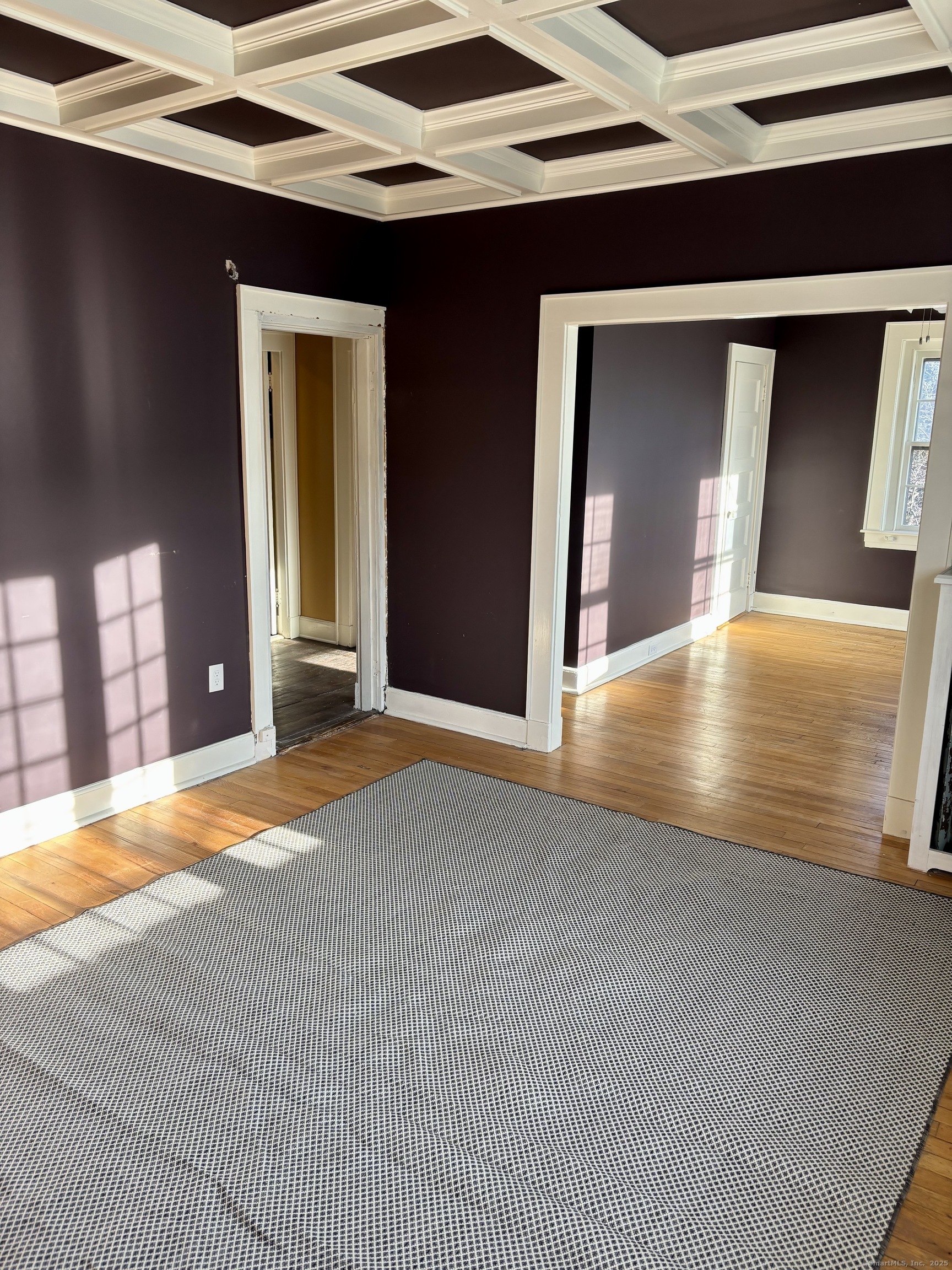 554 Brewster Street, Unit 4 Bridgeport, CT 06605 - Photo 6 of 24 a view of an empty room with wooden floor and a window
