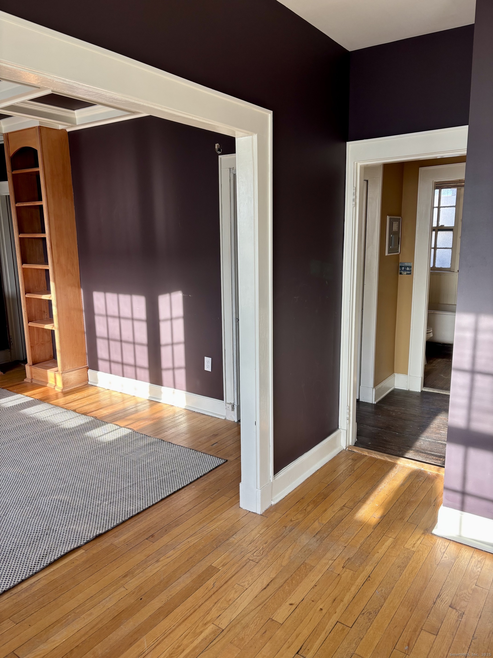 554 Brewster Street, Unit 4 Bridgeport, CT 06605 - Photo 9 of 24 a view of an empty room with wooden floor and a window