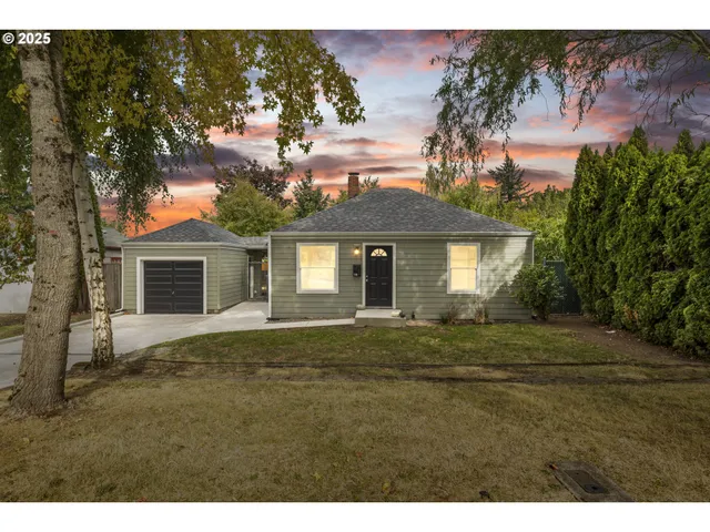 a front view of a house with a garden