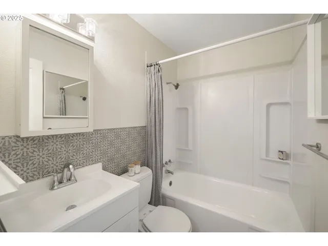 a bathroom with a sink mirror toilet and bathtub