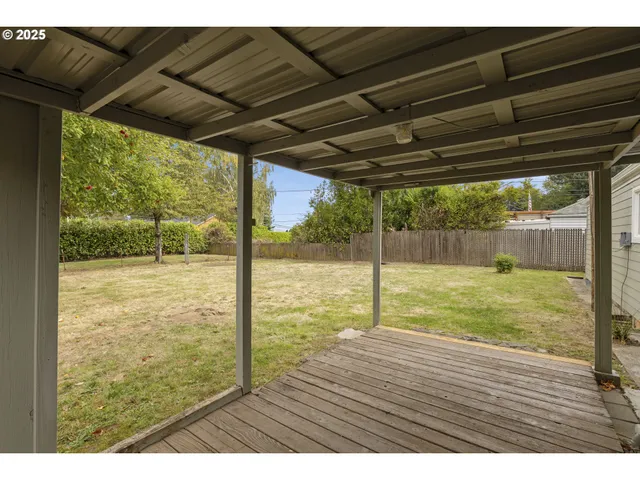 a view of a room with wooden floor and outdoor space