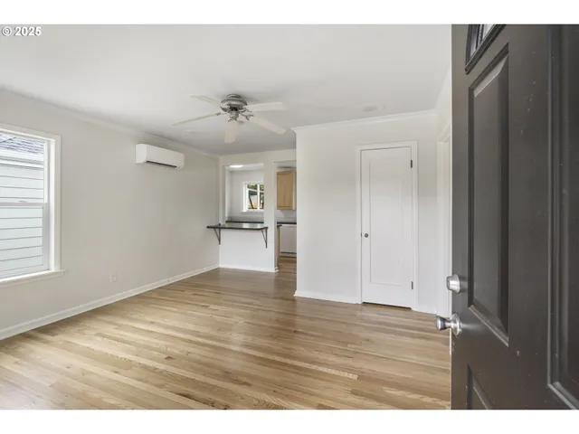 a view of empty room with wooden floor