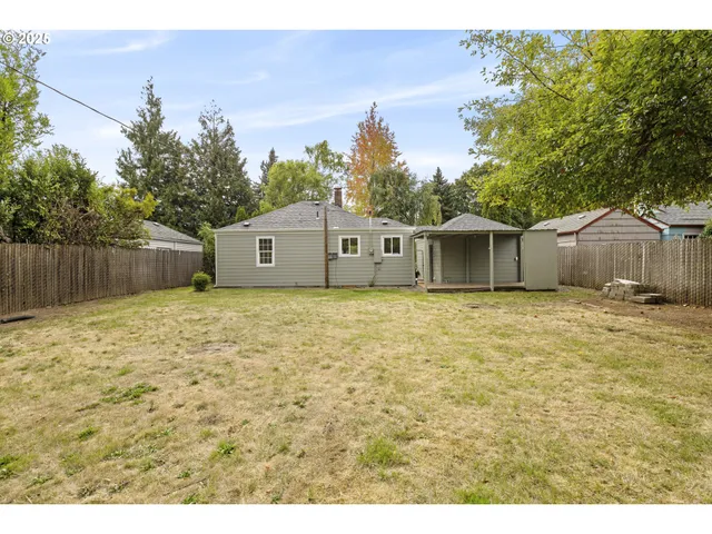 a front view of a building with street sign and sign board
