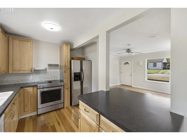 a kitchen with granite countertop a stove and cabinets