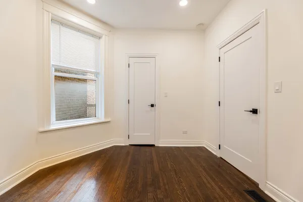 a bathroom with a sink a toilet a mirror and shower
