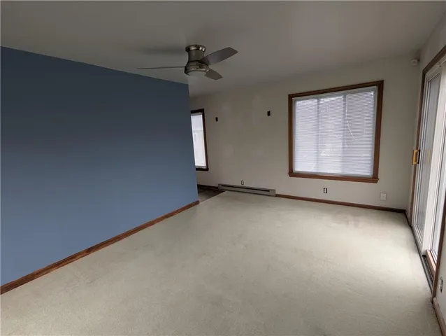 an empty room with a empty space and windows