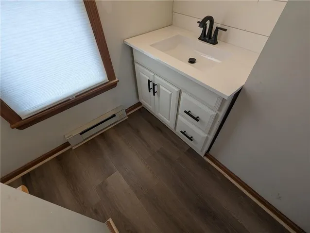 a white cabinet in a bathroom