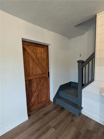 a view of front door with wooden floor and door