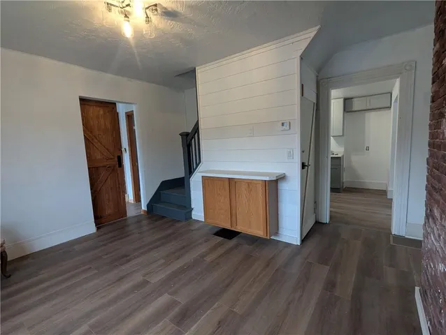 an empty room with wooden floor and closet