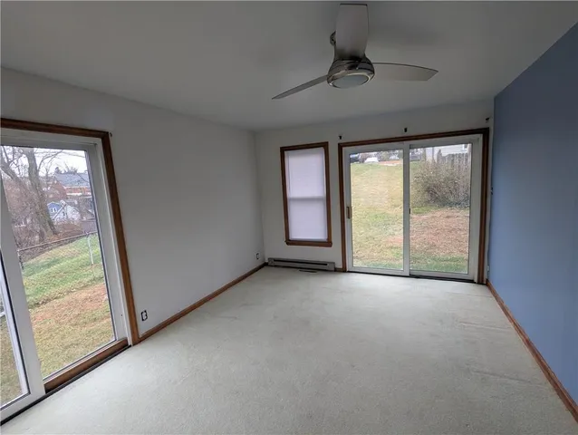 a view of an empty room with windows