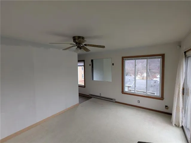 an empty room with a empty space and windows