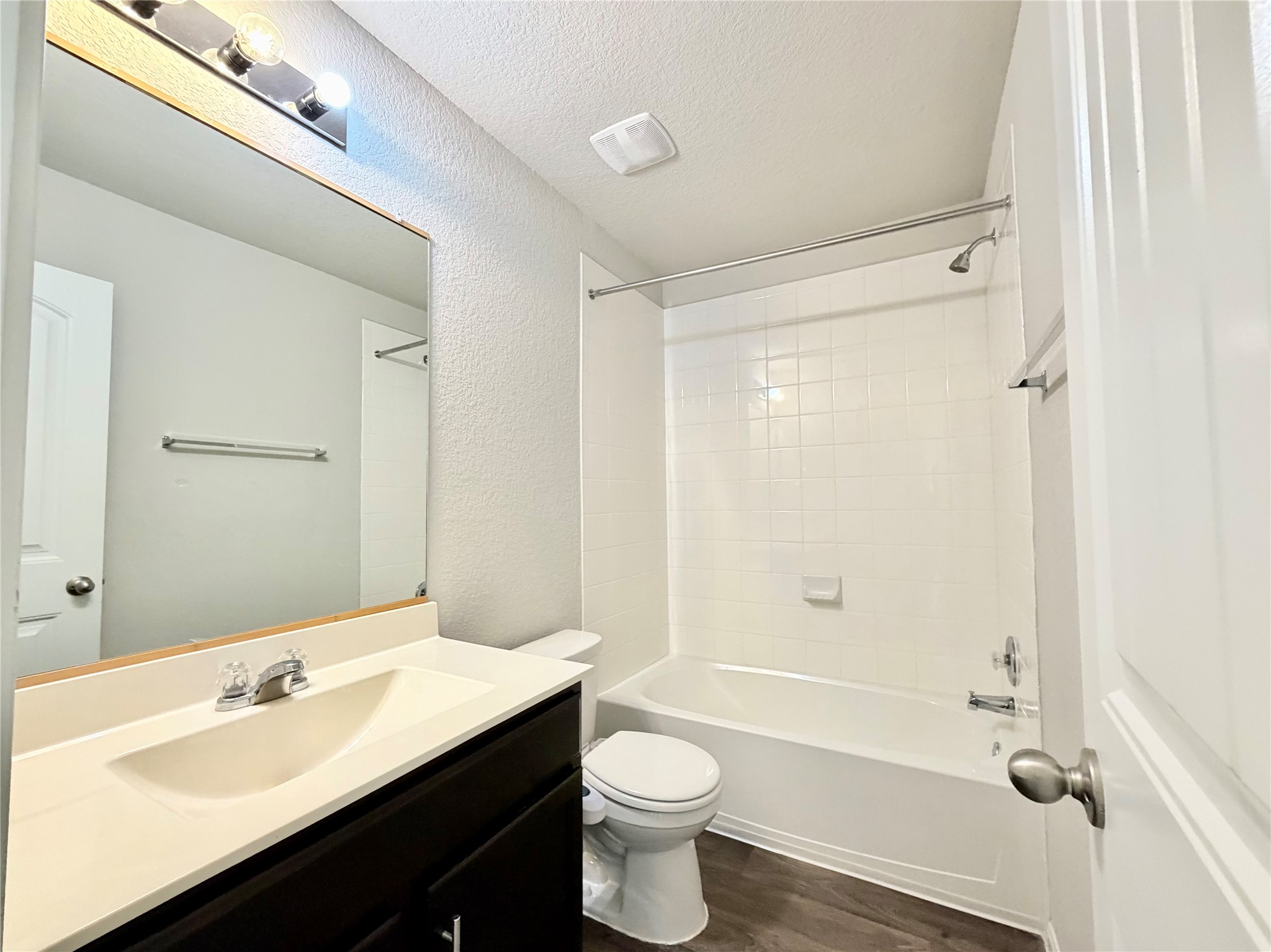 10502 Fulton Avenue Austin, TX 78754 - Photo 32 of 36 A well-maintained full bathroom featuring a tub and shower combination with clean tile surround.