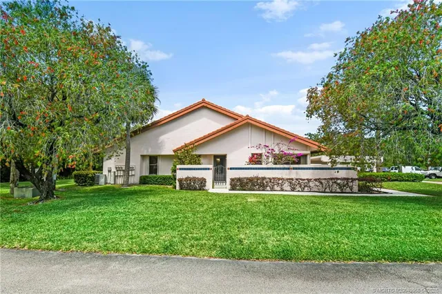 a front view of house with yard and green space