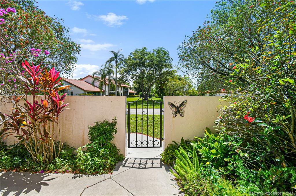 3401 Southeast Martinique Trace, Unit 101 Stuart, FL 34997 - Photo 11 of 51 a view of a flower in a garden