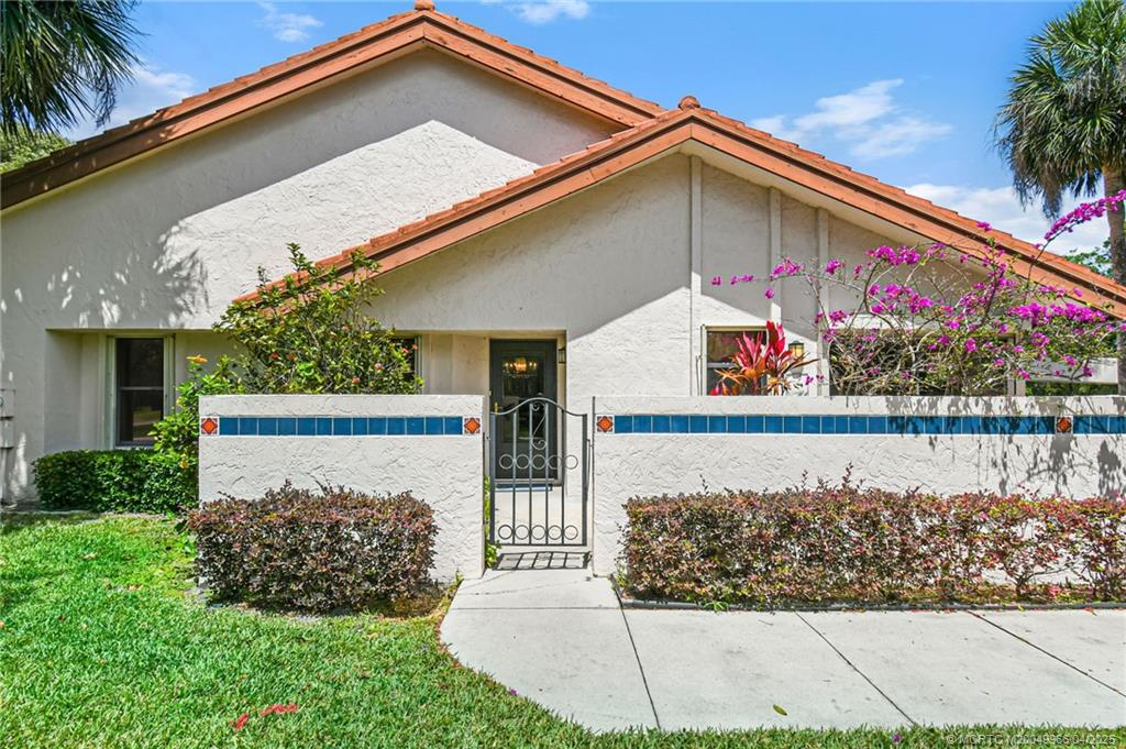3401 Southeast Martinique Trace, Unit 101 Stuart, FL 34997 - Photo 12 of 51 a front view of house with outdoor space and swimming pool