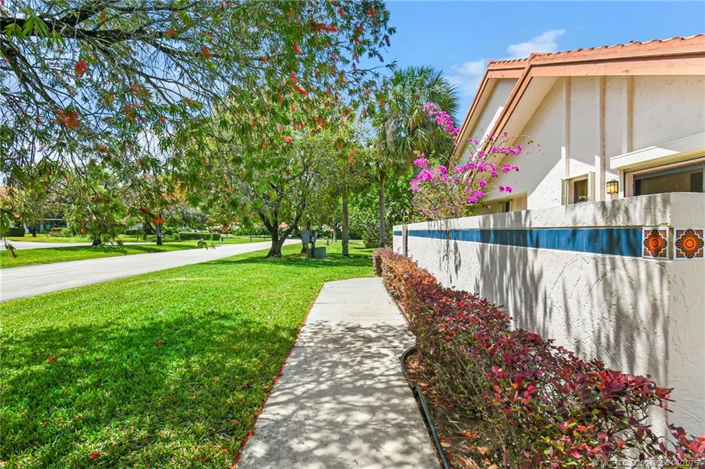 3401 Southeast Martinique Trace, Unit 101 Stuart, FL 34997 - Photo 13 of 51 a view of park with large trees and playing area of childrens