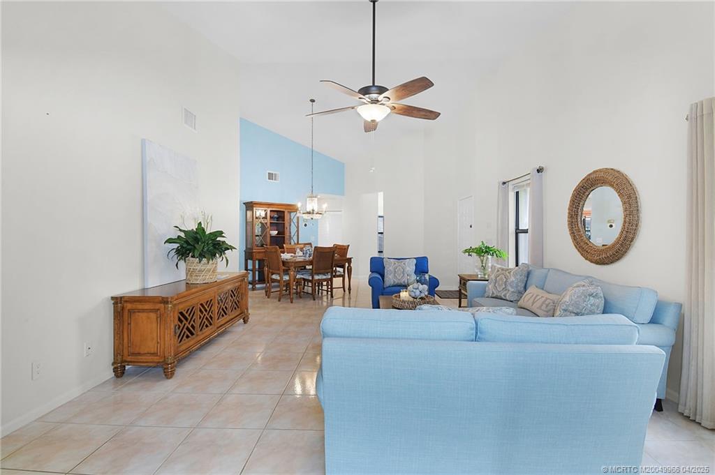 3401 Southeast Martinique Trace, Unit 101 Stuart, FL 34997 - Photo 19 of 51 a living room with furniture and a mirror