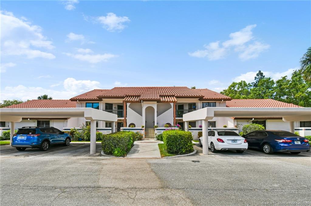 3401 Southeast Martinique Trace, Unit 101 Stuart, FL 34997 - Photo 2 of 51 a car parked in front of a house