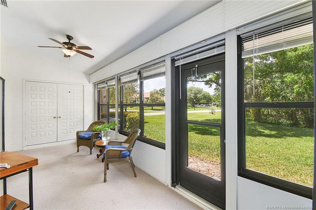 3401 Southeast Martinique Trace, Unit 101 Stuart, FL 34997 - Photo 22 of 51 a living room with hardwood floor and balcony view