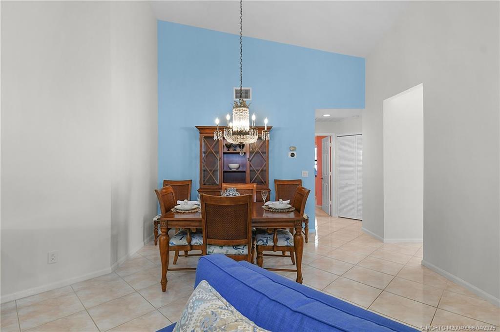 3401 Southeast Martinique Trace, Unit 101 Stuart, FL 34997 - Photo 30 of 51 a dining room with furniture and wooden floor