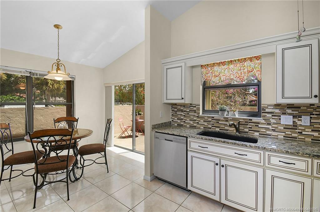 3401 Southeast Martinique Trace, Unit 101 Stuart, FL 34997 - Photo 36 of 51 a kitchen with white cabinets and sink