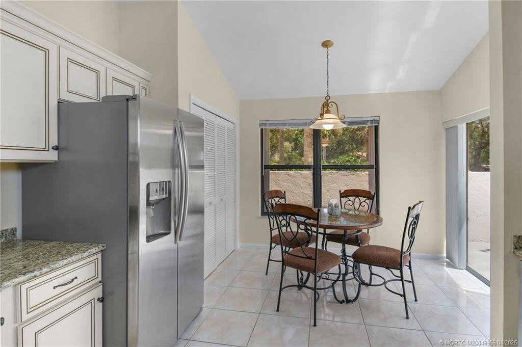 3401 Southeast Martinique Trace, Unit 101 Stuart, FL 34997 - Photo 37 of 51 a dining room with furniture and window