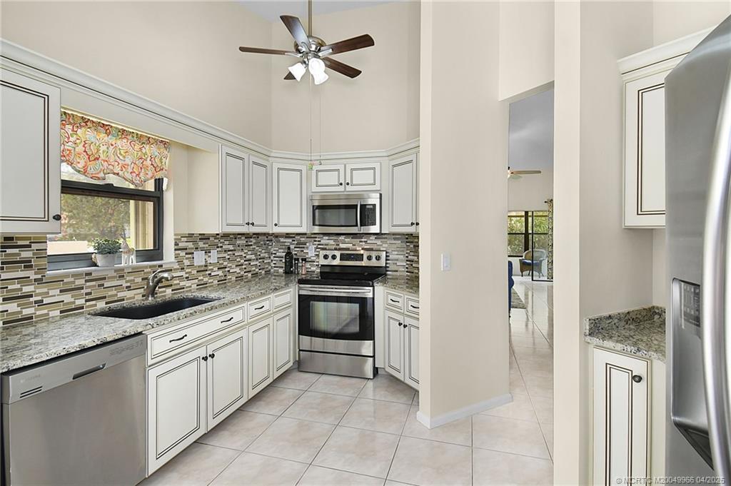 3401 Southeast Martinique Trace, Unit 101 Stuart, FL 34997 - Photo 38 of 51 a kitchen with white cabinets and appliances