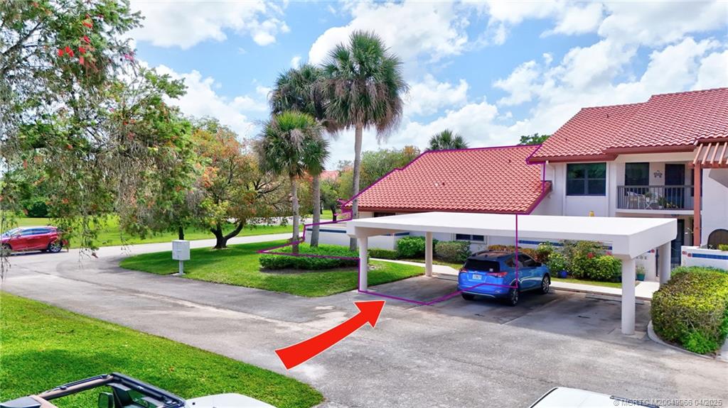 3401 Southeast Martinique Trace, Unit 101 Stuart, FL 34997 - Photo 43 of 51 a view of a house with a yard and sitting area