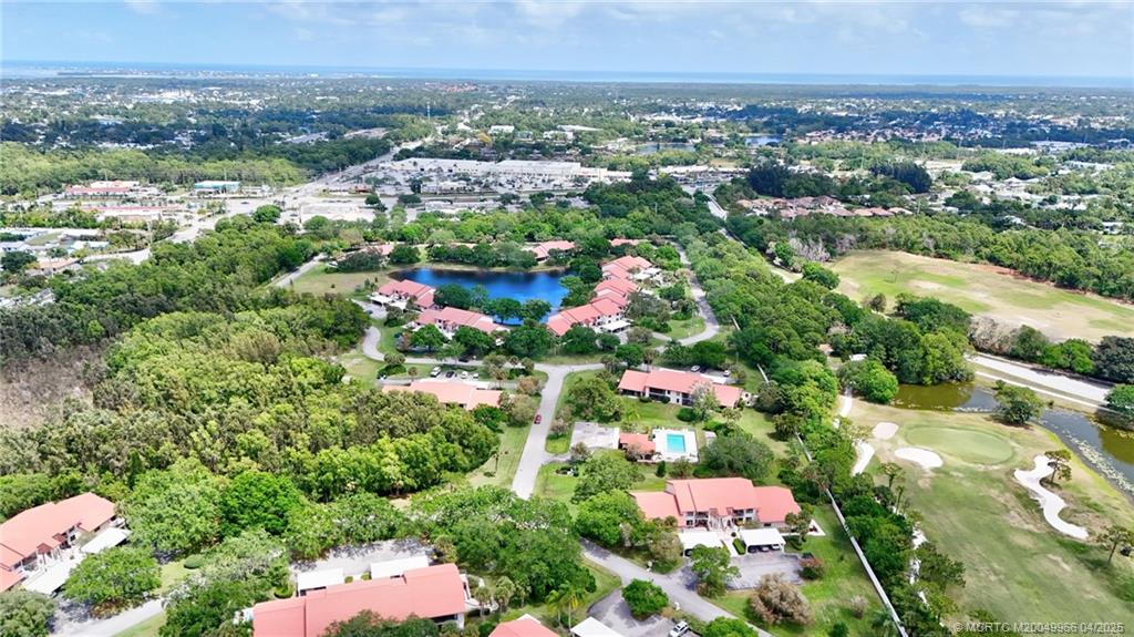 3401 Southeast Martinique Trace, Unit 101 Stuart, FL 34997 - Photo 44 of 51 an aerial view of residential houses with outdoor space and trees