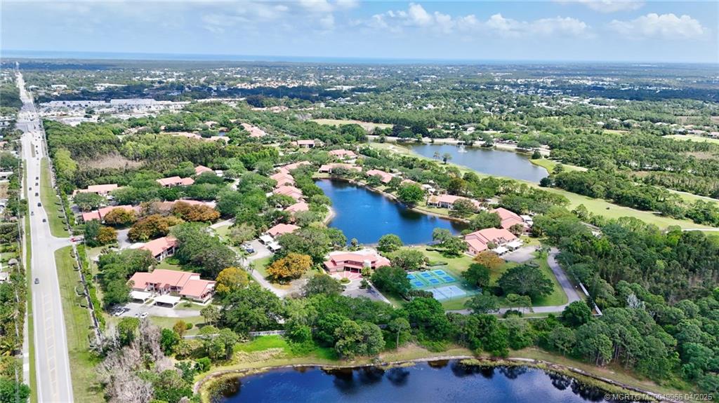 3401 Southeast Martinique Trace, Unit 101 Stuart, FL 34997 - Photo 46 of 51 an aerial view of residential houses with outdoor space and swimming pool