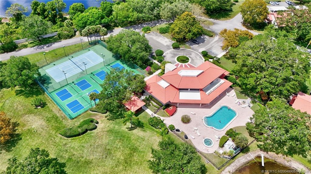 3401 Southeast Martinique Trace, Unit 101 Stuart, FL 34997 - Photo 48 of 51 an aerial view of residential house with outdoor space and swimming pool